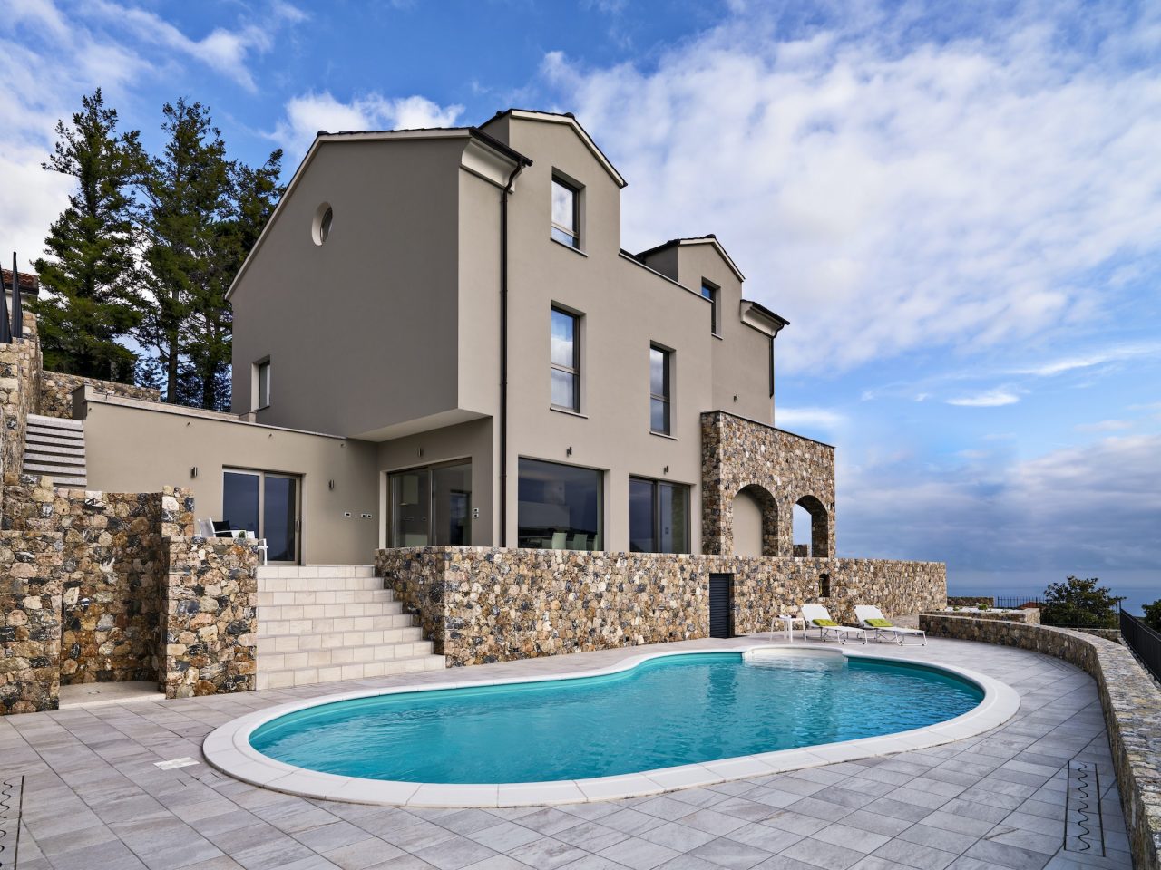 exteriors view of a modern villa in the foreground the swimming pool.jpg